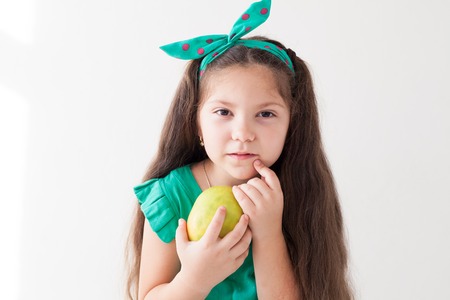 Portrait of a little girl with Green apples niceの写真素材