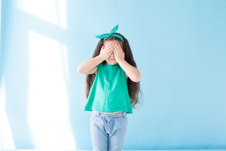 little girl closes herself eyes nice girlの写真素材