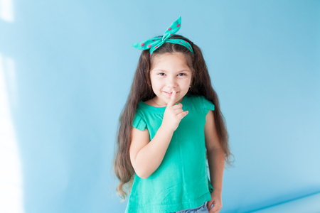 little girl closes her mouth for silenceの写真素材