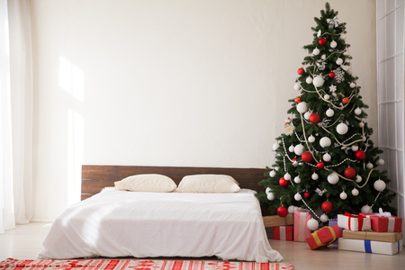 Christmas new year tree Interior bedroom and bed with giftsの写真素材