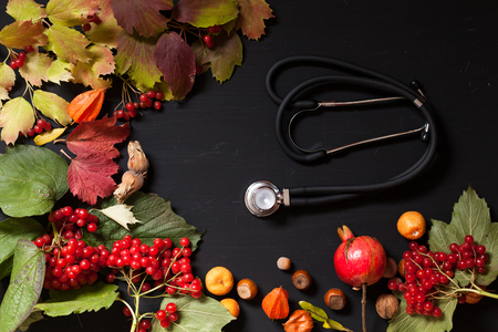 medicine stethoscope and yellow red autumn leavesの写真素材