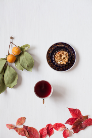 autumn red and yellow leaves of tea and sweet pastryの写真素材
