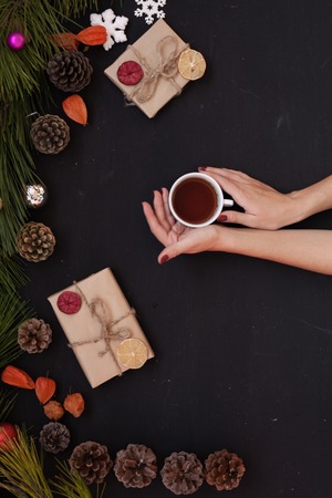 Christmas new year female hands holding Cup of tea giftsの写真素材