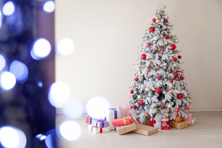 Christmas tree in the white room gifts new year Interiorの写真素材