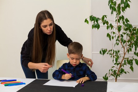 little boy draws markers from lesson motherの写真素材