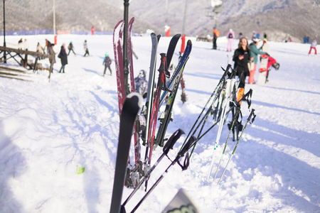 Alpine skis and Snowboards at snow ski resort vacation travelの写真素材