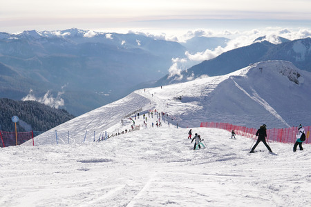 skiers and snowboarders ride on mountain slopes of the ski resort winter vacation travelの写真素材