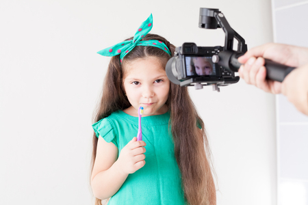 small beautiful girl cleans teeth toothbrush Dentistryの写真素材