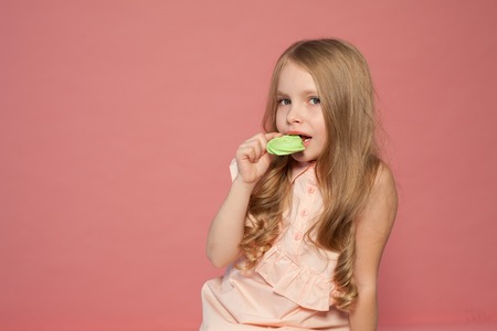 small girl in hand holds a sweet cupcake cake candyの写真素材