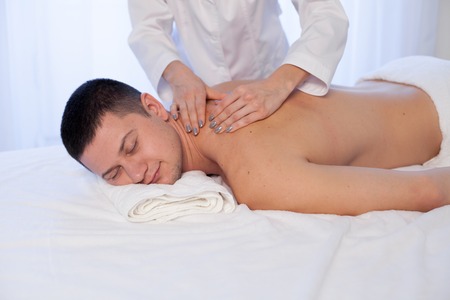 a massage therapist makes therapeutic massage Spaの写真素材