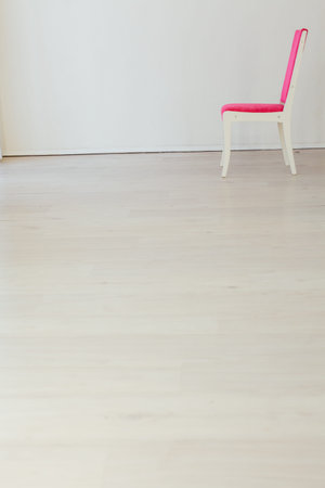 pink chair stands alone in the room