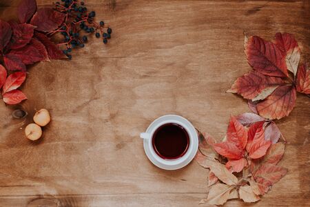 autumn yellow and Red leaves wooden hot cup of coffeeの写真素材