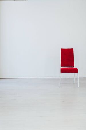 red old chair in the interior of an empty white roomの写真素材