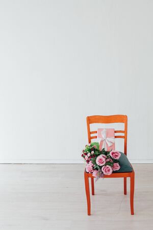 one chair with flowers in the interior of a white empty roomの写真素材