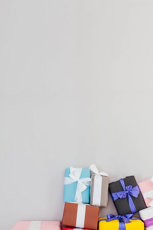 lots of colorful gifts on a grey backgroundの写真素材