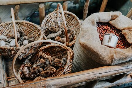 pine cones in baskets with dried rosehipの写真素材