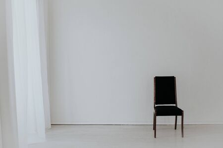 black vintage chair in the interior of an empty roomの写真素材