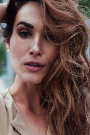 Portrait of a beautiful woman in a beige dressの写真素材