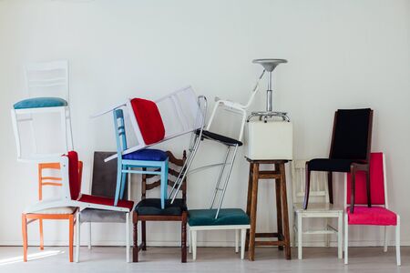 lots of different multicolored chairs in the interior of the white roomの写真素材