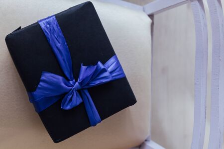 black gift with blue ribbon for birthdayの写真素材
