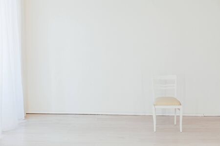 old vintage chair in an empty white roomの写真素材