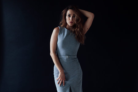 Portrait of a beautiful fashionable woman in a gray dressの写真素材
