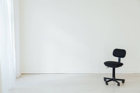 black office chair to work in the interior of the white roomの写真素材