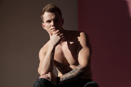 portrait of a beautiful strong fashionable man in stylish clothesの写真素材