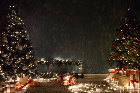 Christmas tree garland lights with gifts of new year holidayの写真素材