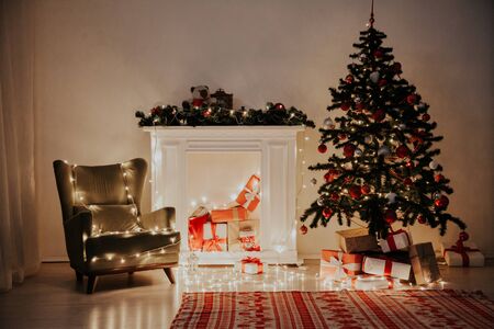 Christmas tree garland lights with gifts of new year holidayの写真素材
