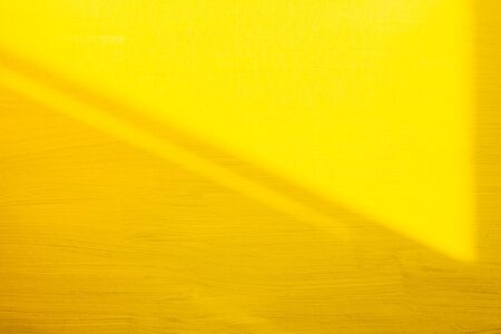yellow-painted wall paint structure as backgroundの写真素材