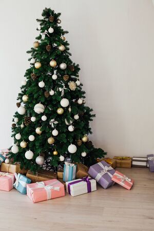 Christmas decor interior of the house Christmas tree with gifts for the new year as a backgroundの写真素材