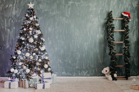 Christmas tree with gifts lights garlands new year winter holidayの写真素材