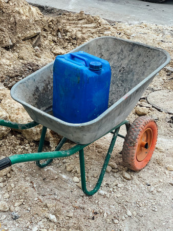 wheelbarrow with blue is on the construction site of the house