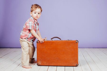 little boy going on a journey with suitcaseの写真素材
