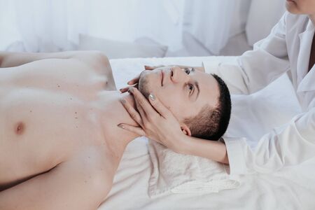 male masseuse makes a therapeutic massage spaの写真素材