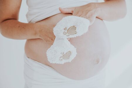 the stomach of a pregnant woman and baby stuff socks 1の写真素材