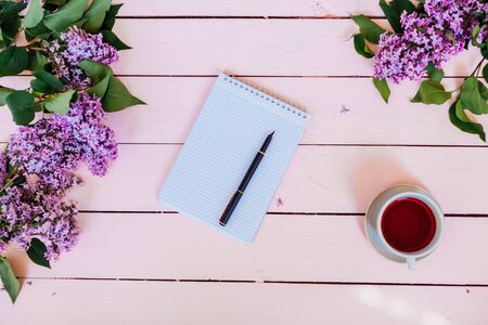 on the white table lilac, gift, notebook, cup of tea 1の写真素材