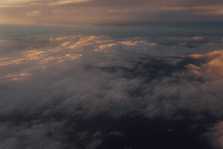 Sky with clouds at sunset from inside plane landscape