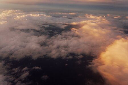 Sunset above the clouds landscape from an airplaneの写真素材