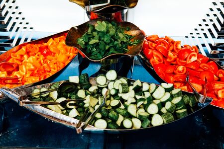 plates with fresh vegetables cucumbers tomatoes foodの写真素材