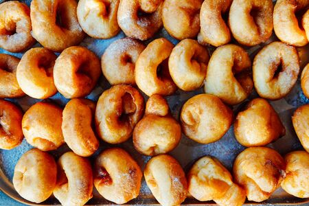 Lots of delicious hot sweet doughnuts to eat as backgroundの写真素材