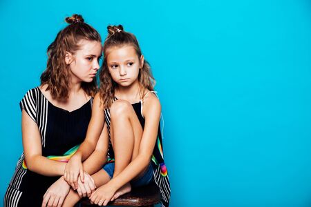 two fashionable girls sisters in beautiful clothes portraitの写真素材