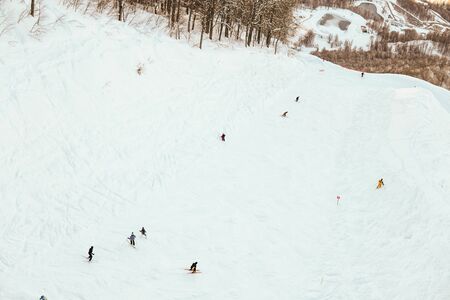 skiers and snowboarders on the track snow skiの写真素材
