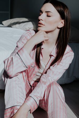 woman in pink Pajamas fashionable portrait bedroomの写真素材