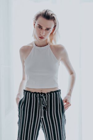 Portrait of a woman blonde on a light backgroundの写真素材