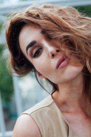 Portrait of a beautiful fashionable woman in a beige stylish dressの写真素材