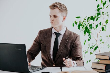 a man works in the Office at the computer business clerkの写真素材