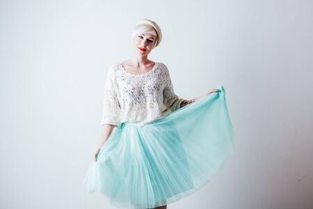 Portrait of a beautiful girl posing on a white backgroundの写真素材