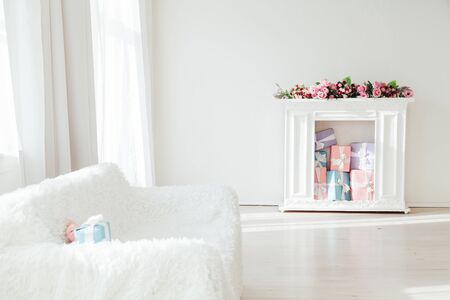 sofa and table with gifts and flowers in the interiorの写真素材